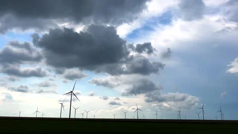 Field landscape with cloudy sky over wind turbines. Stock Footage 243968936