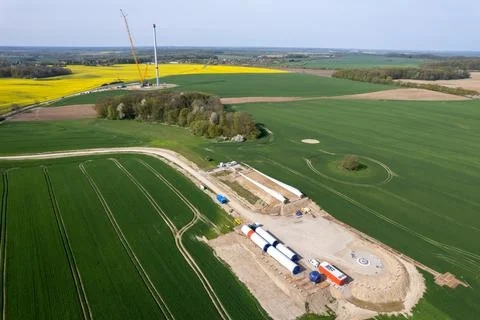 On a field lie the components for a new wind turbine Stock Photos