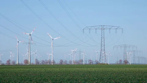 Field with lots of Windmills and Overhead Power Cable Видео 73486653