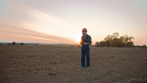 On field man farmer stand hold tablet computer. Digital economy in agribusiness Stock Footage 169481875