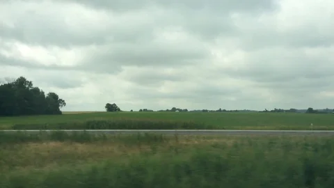 Field next to a highway 2 Stock Footage 92054559