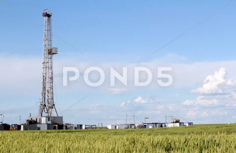 Field with oil drilling rig Stock Photos