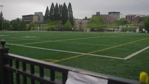 Field pans down to sign that reads "Recreation field is closed due to COVID-19" Video stock 130408006