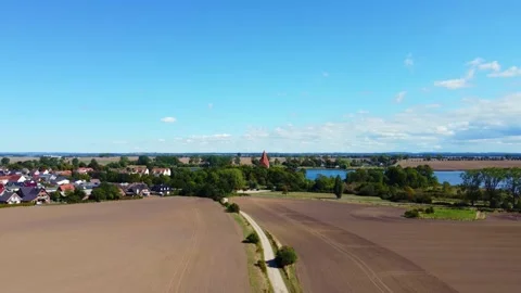 Field path across Akar to the small village. Buttery soft aerial view flight Stock Footage 221637993