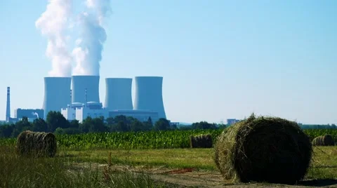 Field with plants (haystacks) - factory (nuclear power station) - smoke Stock Footage
