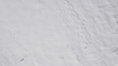 Field Scientist Observes Windshaped Snow Ridges And Seasonal Terrain For Detaile Stock Footage 325984308