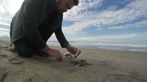 Field scientist sampling sand on a beach Video stock 147696379