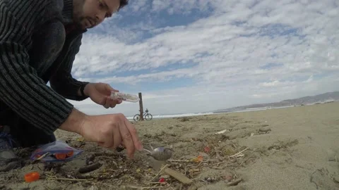Field scientist sampling sand on a beach Video stock 147696478