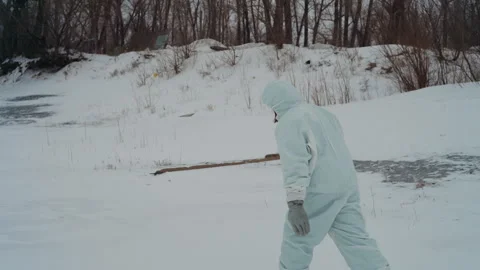 Field scientist surveys winter landscape with focused attention. Researcher in Stock Footage 346472043