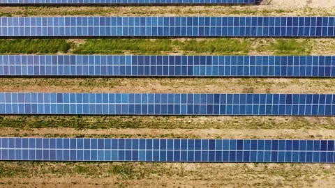 Field with solar panels for power producing. Aerial view of solar power station Stock Footage 139914307
