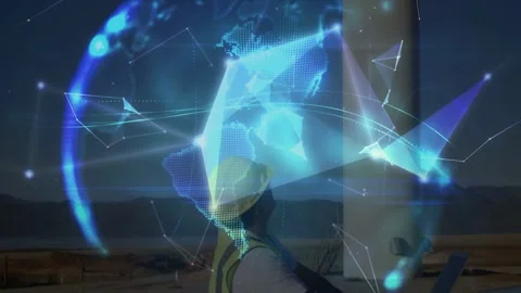 Field tech using laptop at energy tower base as animated nodes forming globe, Stock Footage 332523101