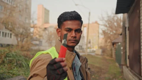 Field technician demonstrating tool usage in city environment. Skilled repair Stock Footage 332504441