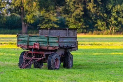 On a field there  are two trailers left by a farmer Stock Photos
