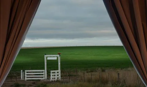 Field through the curtains Stock Photos