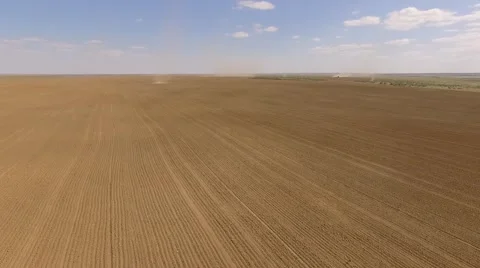 Field with tornadoes and a tractor at the background Aerial shot Видео 68863480