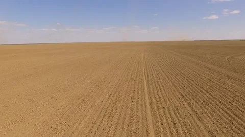 Field with tornadoes at the background Stockbeeldmateriaal 68863332