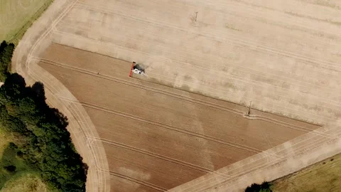 A field with a tractor in the middle Stock Footage 297950759