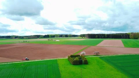 On the field, the tractor works the land Stock Footage 154372959