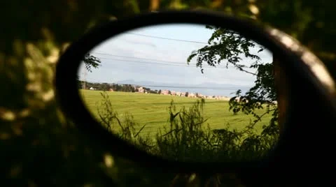 Field of wheat on hill in a side mirror Stock Footage 11114999