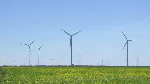 Field of windmills in spring. Renewable energies Stock Footage 154367381