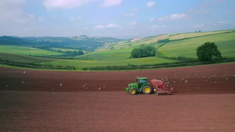 Field work on a tractor from a drone, Devon, England, Europe Video stock 160998535