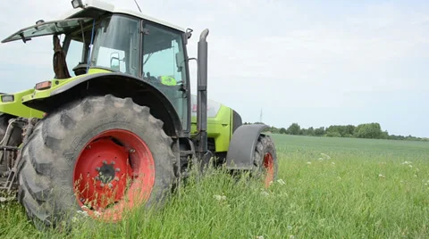 Field work tractor in meadow Stock Footage 33827412