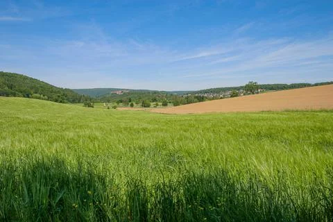Fields and forested mountains of a low mountain range in Germany Stock Photos