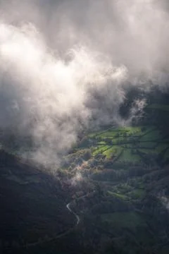 Fields and forests illuminated by a ray of sunlight piercing through banks .. Фото