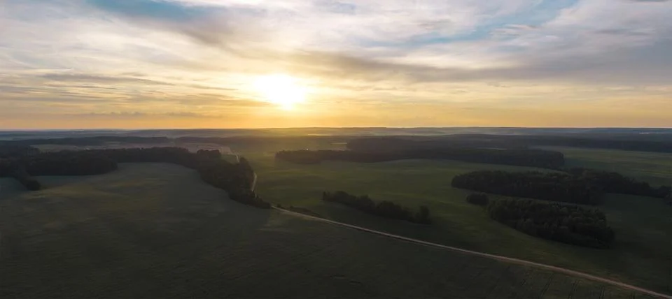 Fields and forests at sunset. Stock Photos
