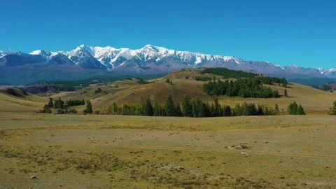 Fields and mountains with snow-capped peaks Video stock 169625458