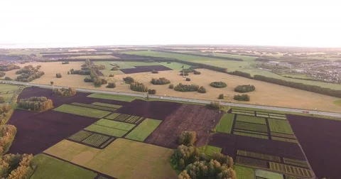 Fields for arable land and a road at sunset Video stock 84217601