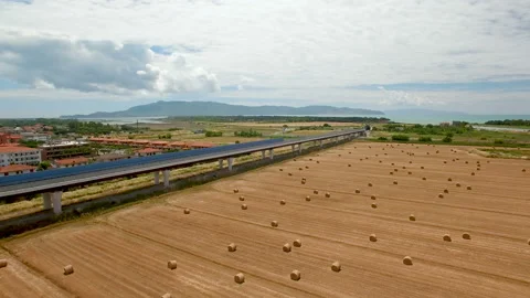 On the fields are stored bales of hay next the highway Stock Footage 87093375