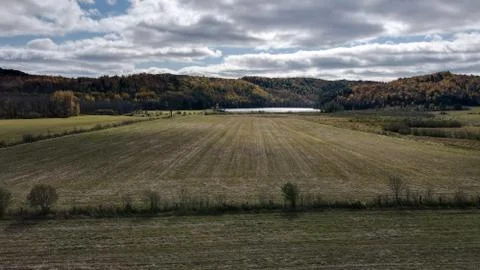 Fields leading towards a small lake Stock Photos