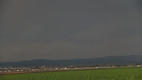 Fields with mountains in background on a gloomy day Stock Footage 109171028