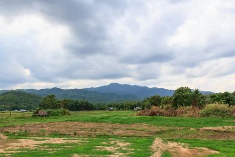 Fields, mountains, clouds Stock Photos