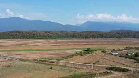Fields, mountains, forest, country roads, concrete pillars, farm building 库存影片 256599602