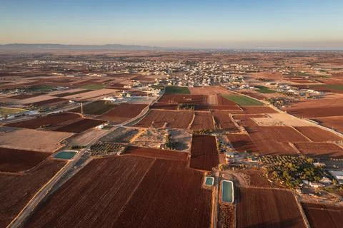 Fields with red soil and Avgorou village in Famagusta District in Cyprus Stock Photos