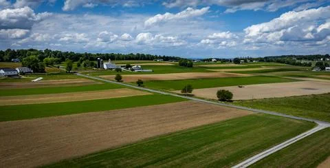 Fields Stretching Under a Blue Sky With Clouds in a Rural Landscape During .. Stock Photos