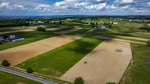 Fields Stretching Under a Blue Sky With Clouds in a Rural Landscape During .. Stock Photos