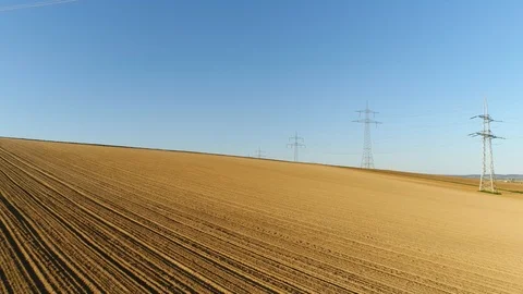 Fields of wheat. Electric supports against the sky among empty yellow fields Stock Footage 124463995