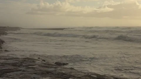 Fierce Ocean Waves Crash Onto Sandy Beach After a Storm at Sunset Видео 341683966