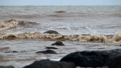 Fierce waves on the beach that hit the black coral Stock Footage 123151483