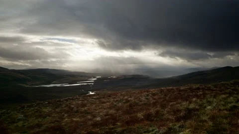 Fierce winds and shafts of light pierce dark clouds to highlight a Video stock 231743540