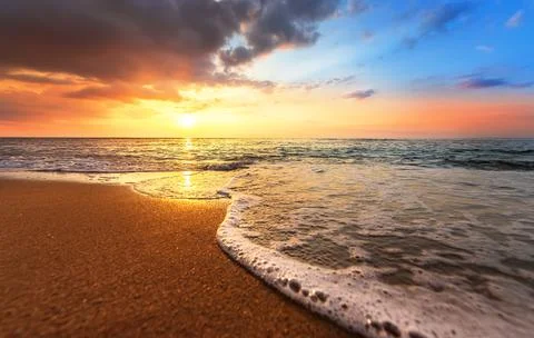 Fiery and dramatic sunset across the lake in summer . Stock Photos