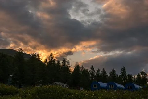 Fiery clouds at sunset in the Altai mountains Stock Photos