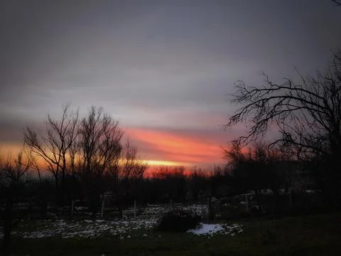 Fiery Cloudscape Over a Dark and Dramatic Natural Landscape 스톡 사진