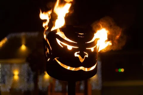 Fiery Devil Face Torch Illuminating a Dark Winter Night Scene Stock Photos