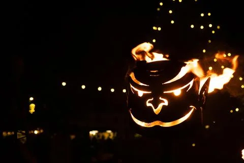 Fiery Devil Face Torch Illuminating a Dark Winter Night Scene Stockfoto's