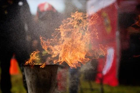 Fiery Display. Firefighters practice controlling an outdoor fire with Stock Photos