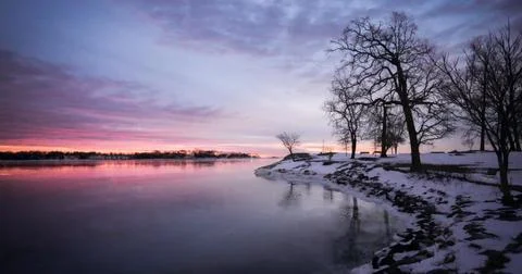 Fiery Dramatic Sky at Dawn over Calm Lake Silhouette Stock Photos